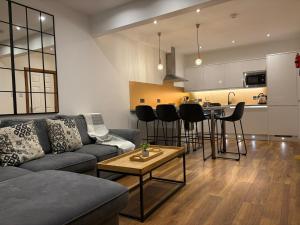 a living room with a couch and a table at Sheraton Apartments in Fort William