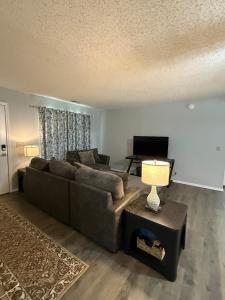 a living room with a couch and a table at Wolf Creek Escape Grove OK in Grove