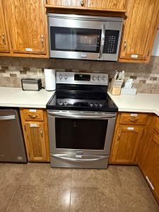 a kitchen with a stove and a microwave at Wolf Creek Escape Grove OK in Grove +33 photos
