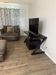 a living room with a flat screen tv on a stand at Wolf Creek Escape Grove OK in Grove