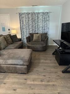 a living room with a couch and a table at Wolf Creek Escape Grove OK in Grove