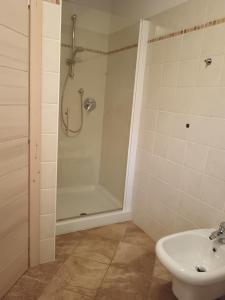 a bathroom with a shower and a toilet and a sink at Fiocco di neve in Valdisotto
