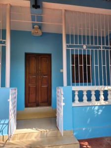 a blue house with a wooden door at Florin Studio in Vagator +2 photos