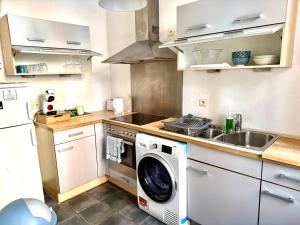 a kitchen with a washing machine and a sink at Central Hub in Brussels +6 photos