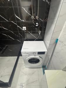 a white toilet in a bathroom with a black wall at Apartman "Paolo" Istočno Sarajevo in Vranješ