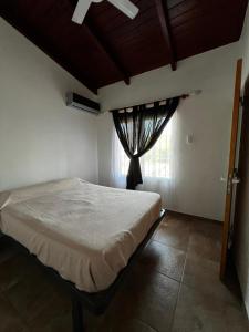 a bedroom with a bed and a window at La Soñada in Miramar