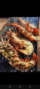 a bunch of food cooking on a grill at PiNkeY 19 seafood restaurant in Diani Beach