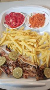 a plate of food with french fries and chicken and chips at PiNkeY 19 seafood restaurant in Diani Beach