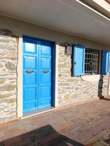 a blue door and a window on a building at La Panciotta in Azzano +16 photos