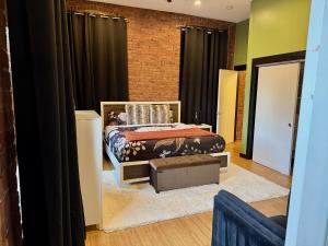 a bedroom with a bed and a brick wall at Brick City Loft in Newark +30 photos