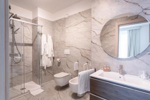 a bathroom with a sink toilet and a mirror at Palazzo Le Giare - Luxury Apartments in Bari +52 photos