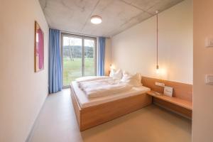 En eller flere senge i et værelse på Ferienhaus Weitsicht