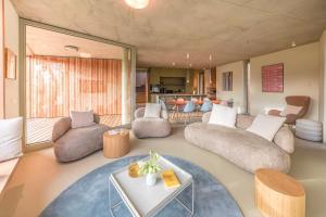 a living room with a couch and chairs and a table at Ferienhaus Weitsicht in Großschönau