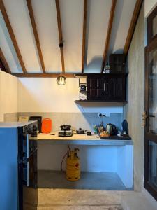 a kitchen with a stove and a counter top at Sunliya Resort in Tangalle