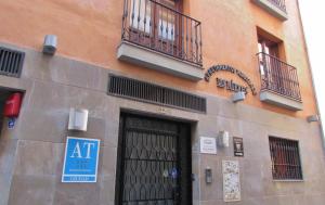 a building with a door and two balconies on it at Apartamentos Turísticos Las Nieves in Granada