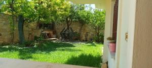 an outside view of a yard with grass and trees at NEAR AIRPORT 2 STOPS By METRO, STATION METRO"PEANIA-KANTZA" in Leondárion