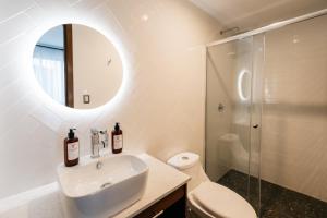 a white bathroom with a sink and a mirror at Casa Castillo Condesa in Mexico City +33 photos