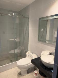 a bathroom with a toilet and a sink and a shower at Vista a Mar in Huaral +25 photos