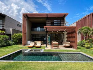 an exterior view of a building with a patio and a pool at The house - Casa Coral in Trairi
