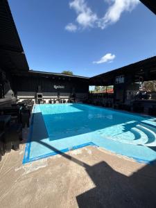 a large swimming pool with a blue at Hotel la Finca Inn in Matamoros