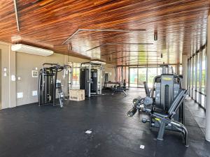 a gym with several treadmills and machines in it at The house - Casa Coral in Trairi