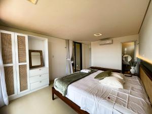 a bedroom with a large bed and a mirror at The house - Casa Coral in Trairi +29 photos