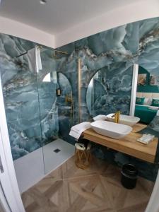 a bathroom with two sinks and a shower at boutique teatro b&b in Foggia