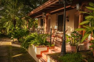a porch of a house with a bunch of plants at Altos de Fontana by Macondo Collection in Managua +24 photos