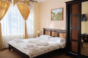 een slaapkamer met een bed met handdoeken erop bij Pensiunea Crocus - Sauna & Billiard in Poiana Brasov