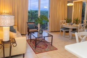a living room with a couch and a table at Altos de Fontana by Macondo Collection in Managua