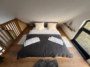 a bedroom with a bed with black blankets and pillows at Arbor in Vadul lui Carol II +31 photos