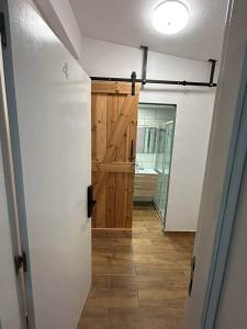 a hallway with a wooden door in a room at Suite Privada & Acogedora in Puerto del Rosario