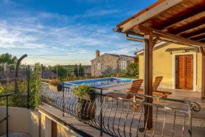 a balcony with chairs and a swimming pool at Casa Romina in Višnjan