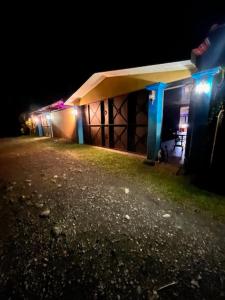 a building at night with lights on it at La casa de MR in Sarapiquí