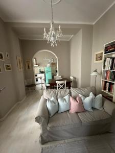 a living room with a couch with pillows at La Fatina appartamento in Collodi