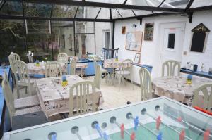 a room with tables and chairs and a swimming pool at Thatched 2persons Cottage in Currahy Bridge