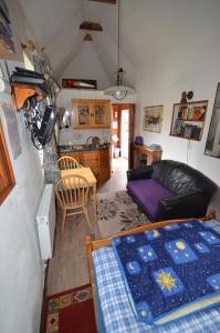 a living room with a couch and a table at Thatched 2persons Cottage in Currahy Bridge