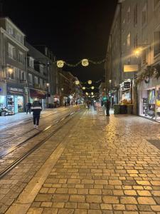 a person walking down a city street at night at Hypercentre Orléans Carmes in Orléans