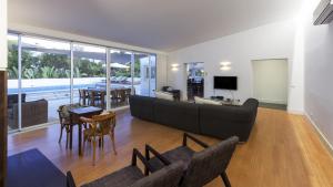 un soggiorno con un divano e un tavolo di Casa dos Pelargónios a Luz