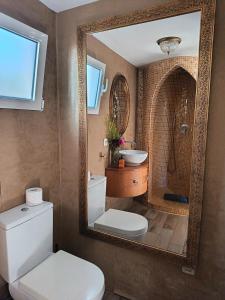 a bathroom with a mirror and a toilet and a sink at Estudio Jazmín in Nerja +46 photos
