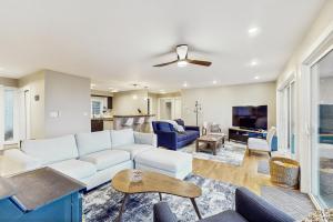 a living room with a white couch and a tv at Saltwind Shores in Moclips