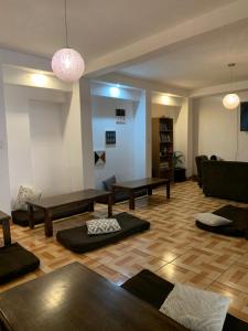 a living room with tables and a couch at Zoola Suites Antigua in Antigua Guatemala