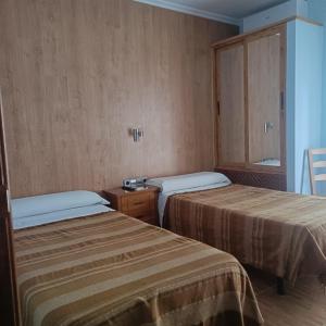 En eller flere senge i et værelse på Hostal Los Palancares