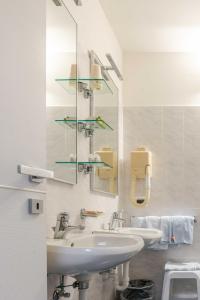 a bathroom with two sinks and a mirror at Hotel POSTA - Comfortable Stay in Ventimiglia in Ventimiglia +228 photos