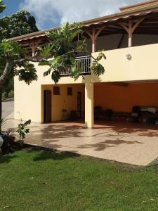 a house with a porch and a patio at Le Refuge de Nicolas in Quartier Morne Acajou