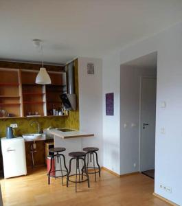 a kitchen with a counter and stools in a room at Studio Deluxe in Tallinn