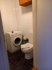 a bathroom with a toilet and a washing machine at Studio Deluxe in Tallinn