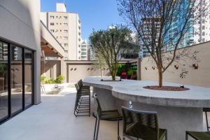 a patio with chairs and a table in a building at Infinity Tower Flat 1105 in Itapema