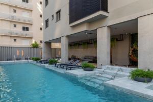 a swimming pool in front of a building at Infinity Tower Flat 1105 in Itapema