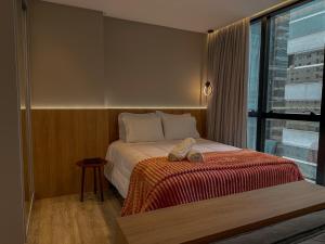 a bedroom with a bed and a window at Infinity Tower Flat 1105 in Itapema +26 photos